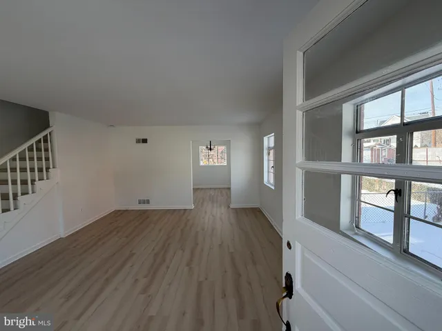 a view of an entryway with wooden floor