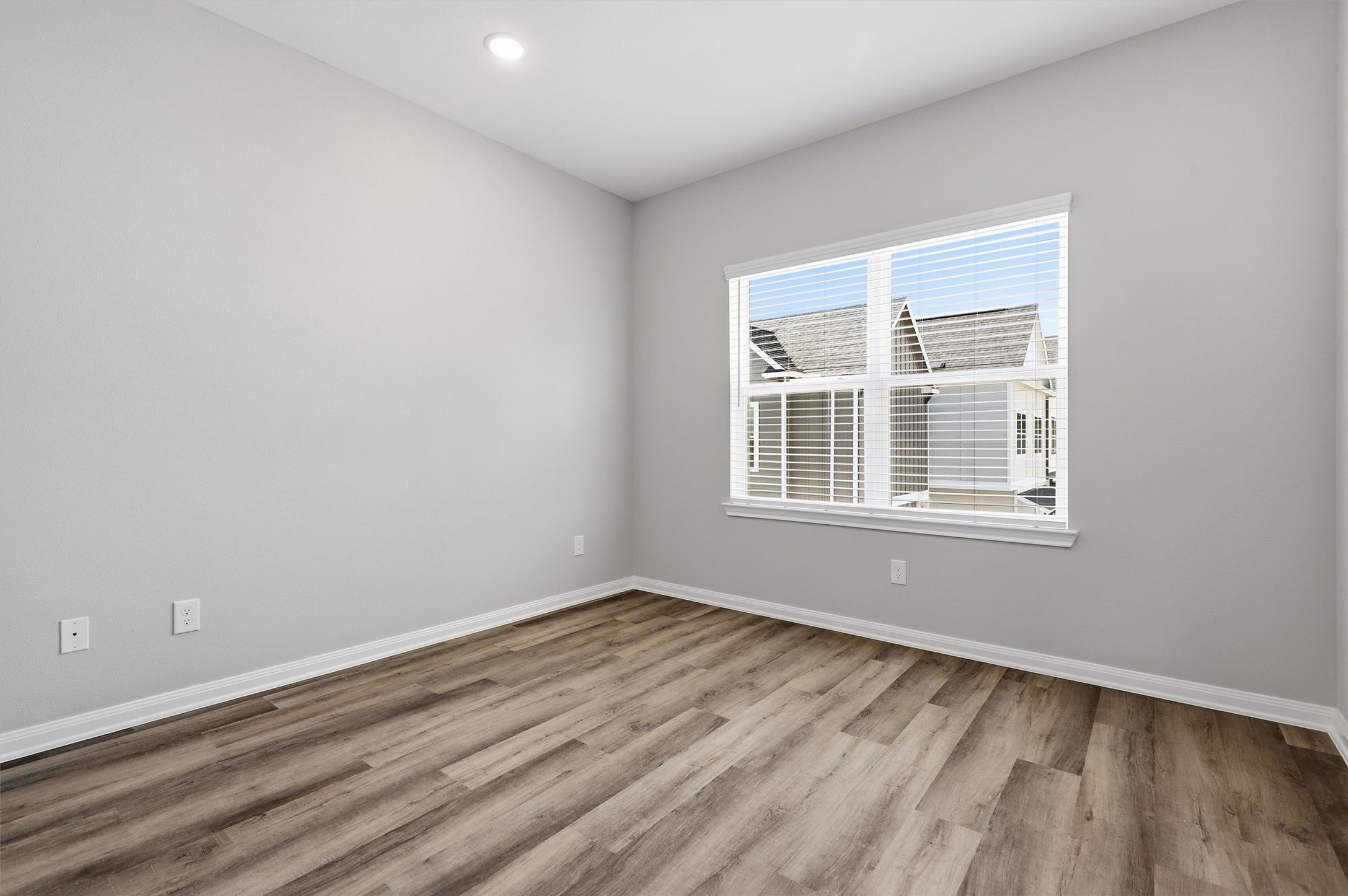 9906 Clark Road Houston, TX 77076 - Photo 29 of 50 an empty room with wooden floor and windows
