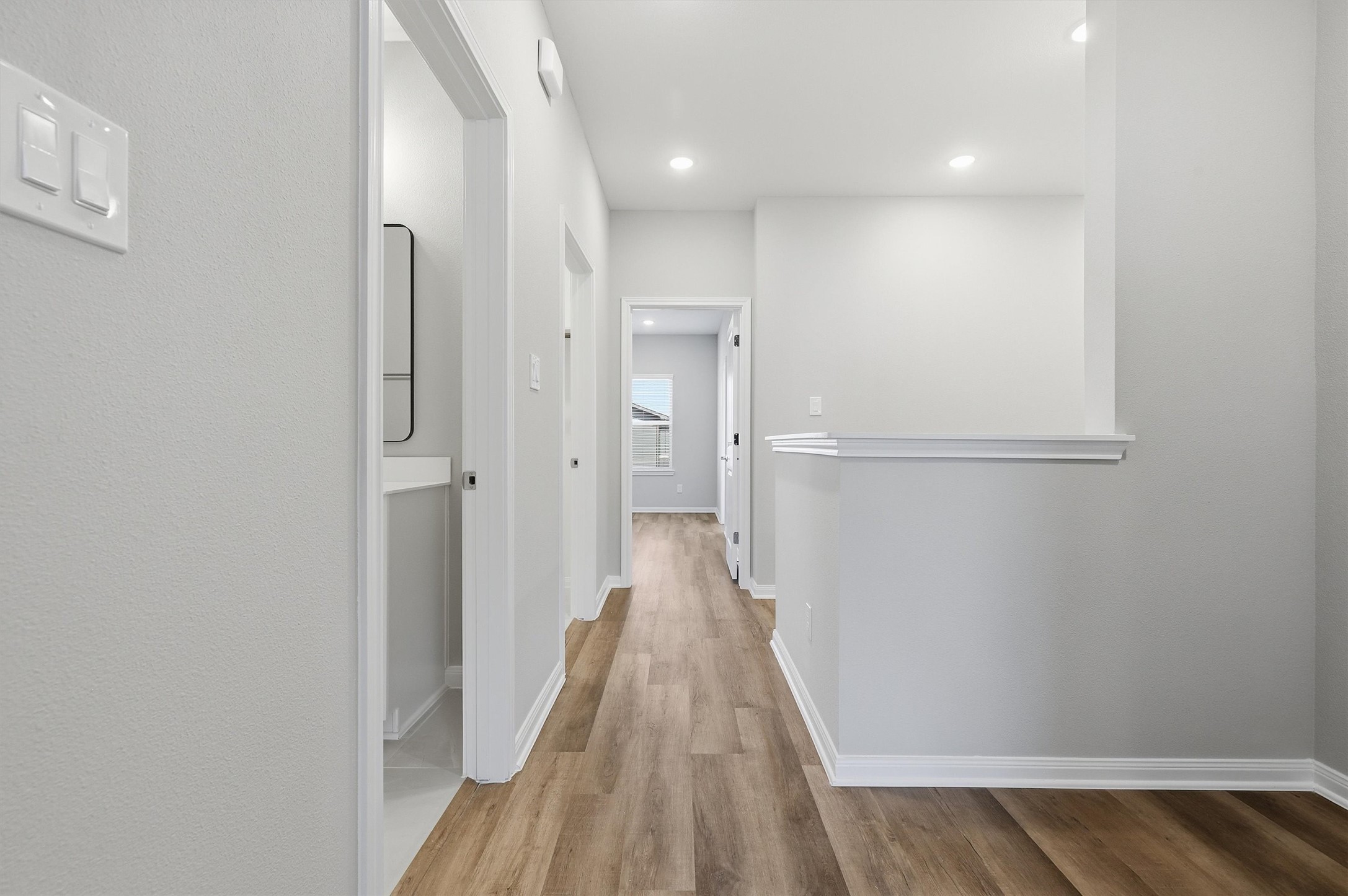 9906 Clark Road Houston, TX 77076 - Photo 36 of 50 a view of a hallway with wooden floor and a bathroom