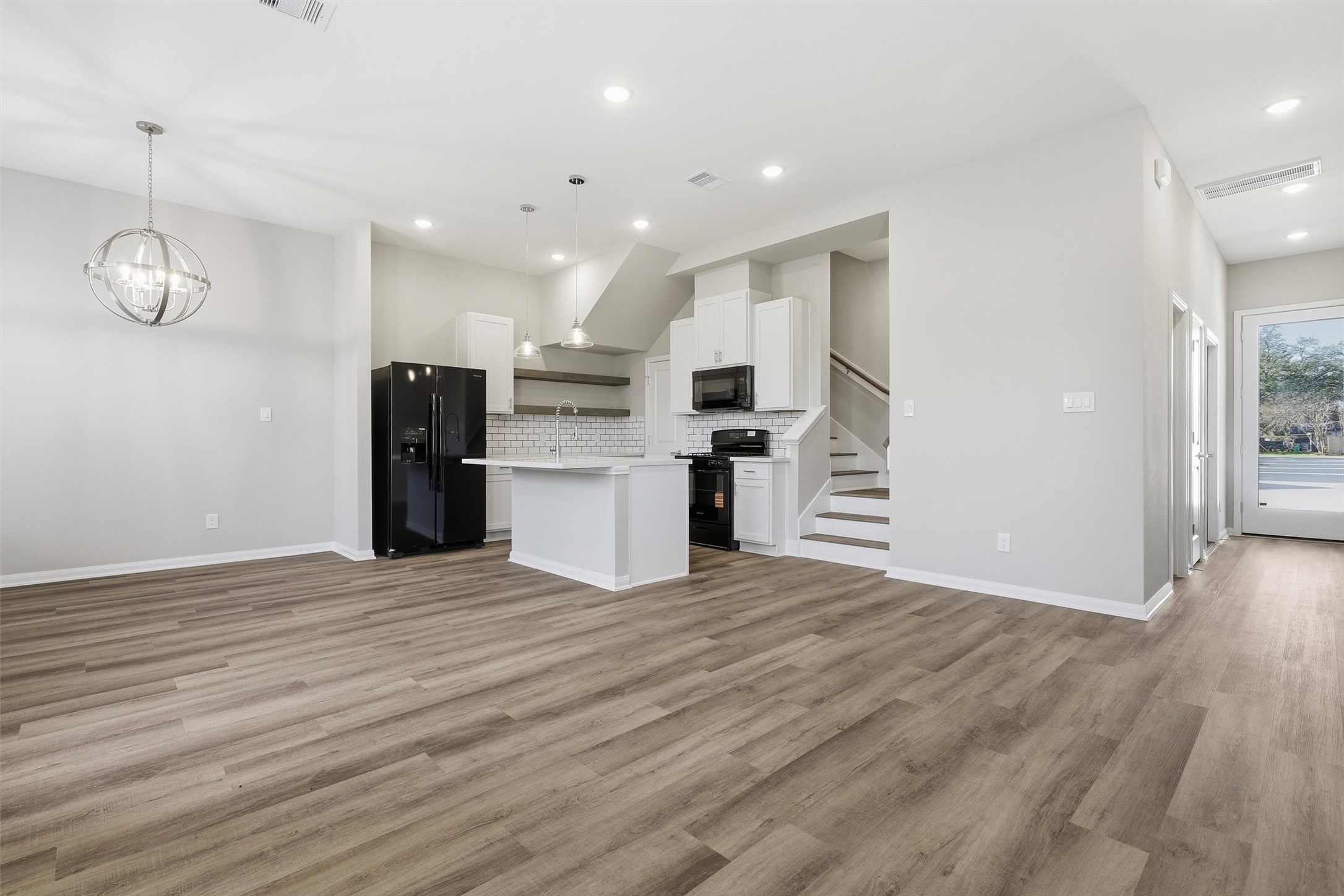 9906 Clark Road Houston, TX 77076 - Photo 44 of 50 a view of a kitchen with a stove cabinets and wooden floor