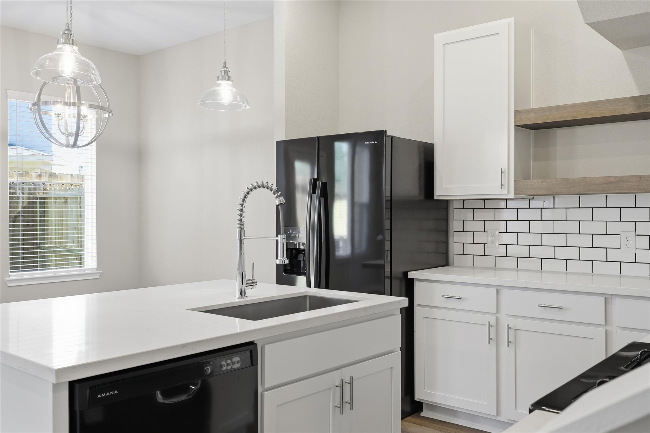 9906 Clark Road Houston, TX 77076 - Photo 9 of 50 a kitchen with a sink cabinets and appliances