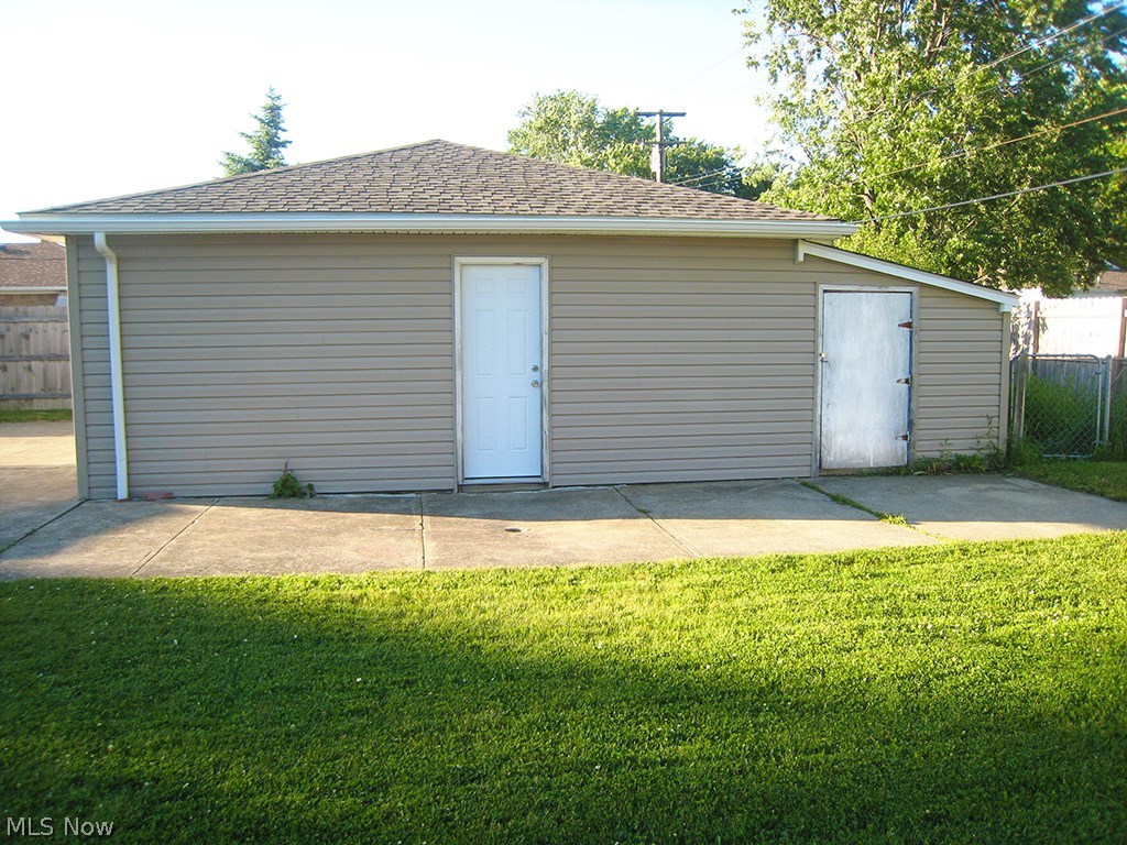 6925 Maplewood Road Parma Heights, OH 44130 - Photo 19 of 25 Oversize 2.5 car garage with vinyl siding and shed at back.