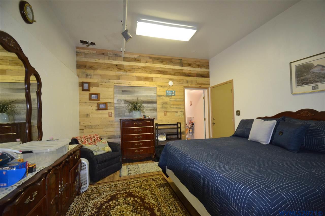 1690 Bayocean Road Northwest Tillamook, OR 97141 - Photo 13 of 25 a bedroom with a bed and wooden floor