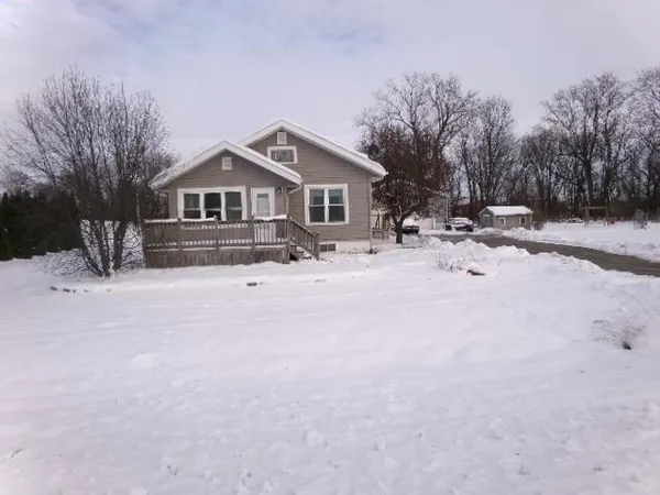 a wooden bench sitting in middle of the snow