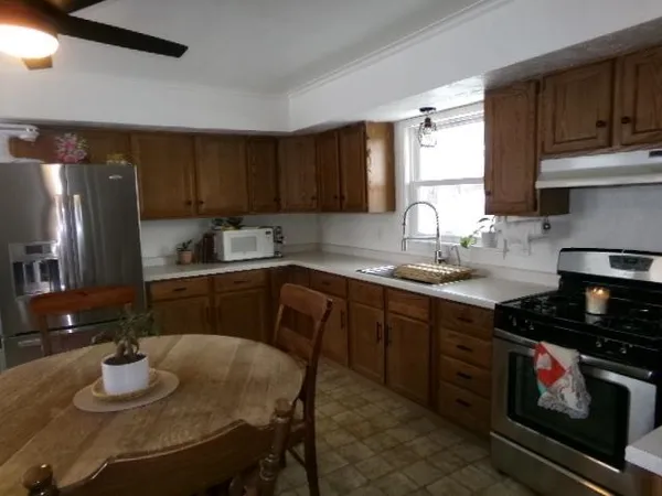 a kitchen with a sink stove and cabinets