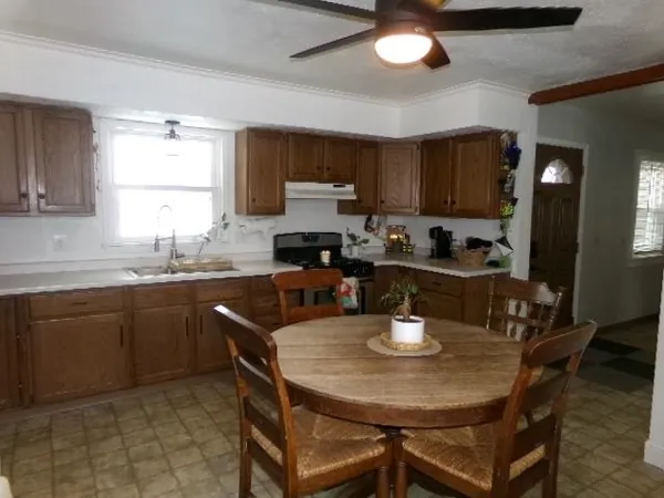 a kitchen with a dining table and chairs
