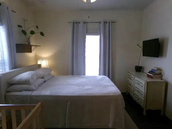 a bedroom with a bed and a flat screen tv