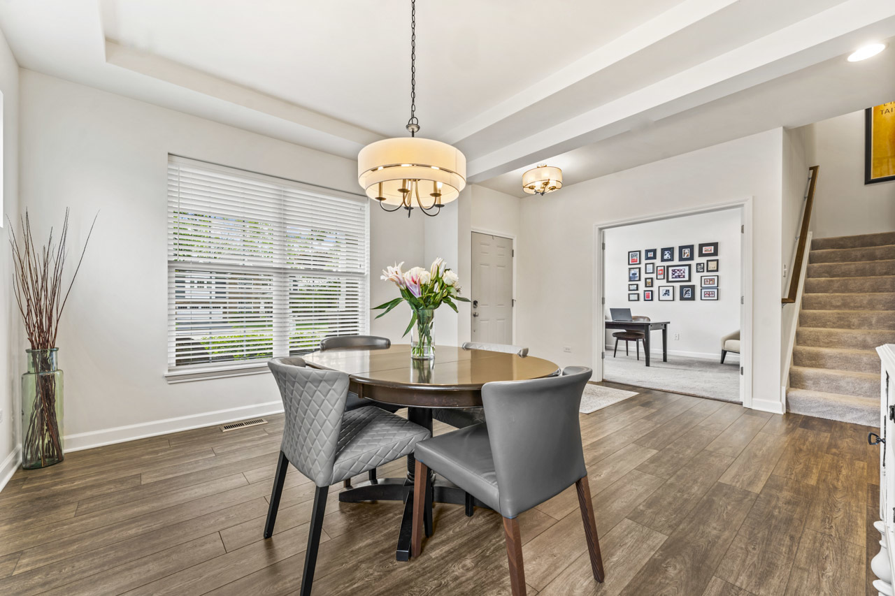 1251 West Thomas Road Wheaton, IL 60187 - Photo 4 of 57 a dining room with wooden floor a chandelier a wooden table and chairs