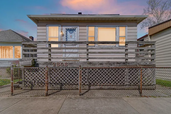 a front view of a house with a gate