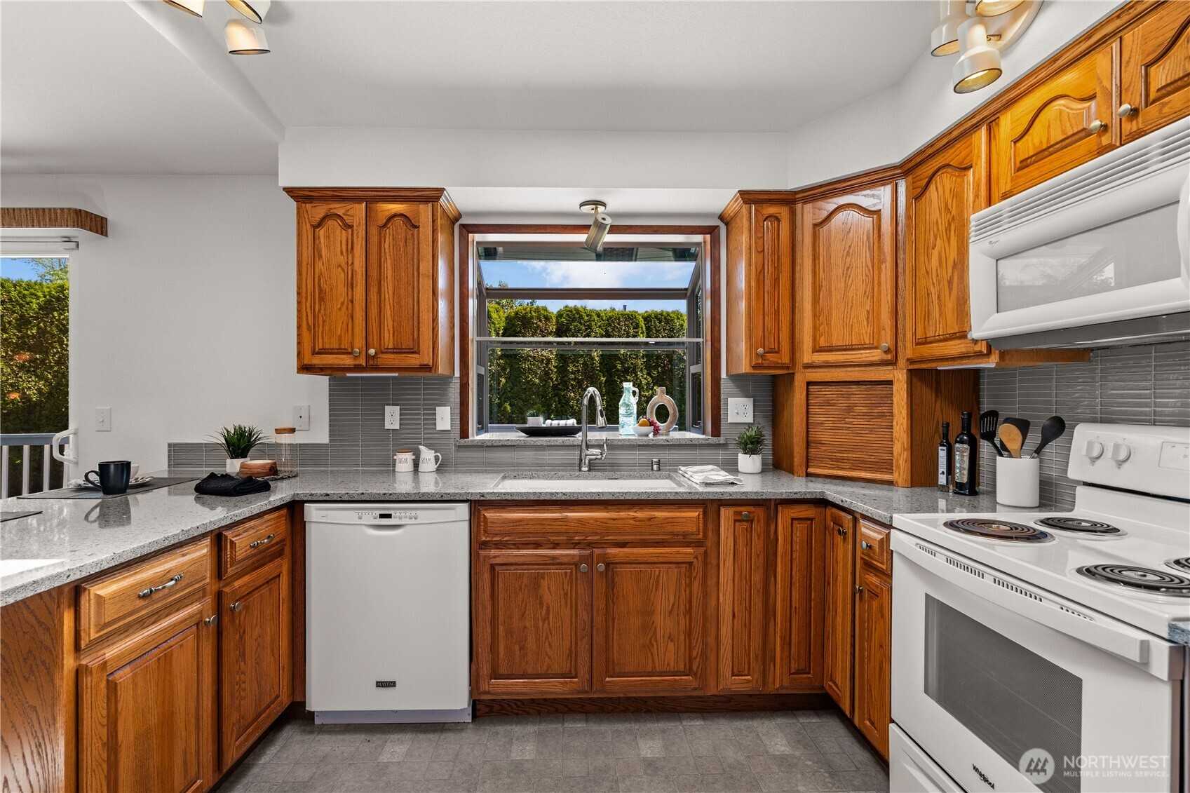 518 Hubbard Road Lynnwood, WA 98036 - Photo 11 of 39 a kitchen with a sink stove and cabinets