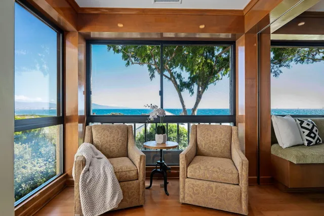 a balcony with furniture and a potted plant