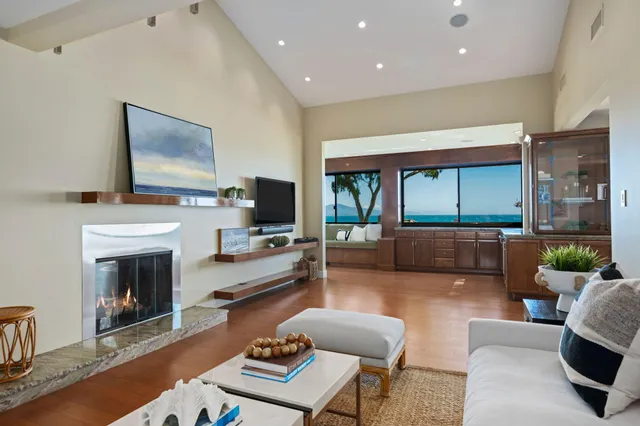 a living room with furniture fireplace and flat screen tv
