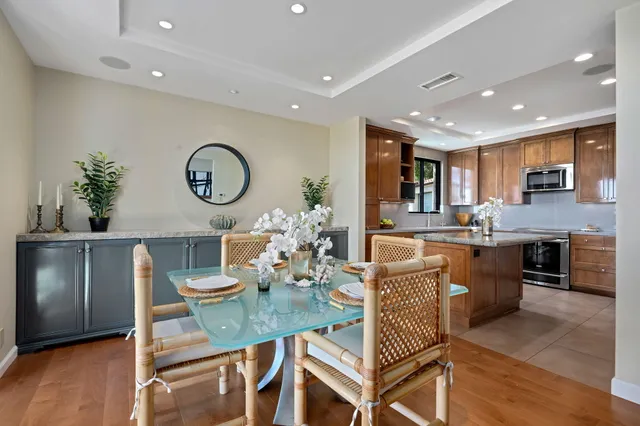 a kitchen with a table chairs and a refrigerator