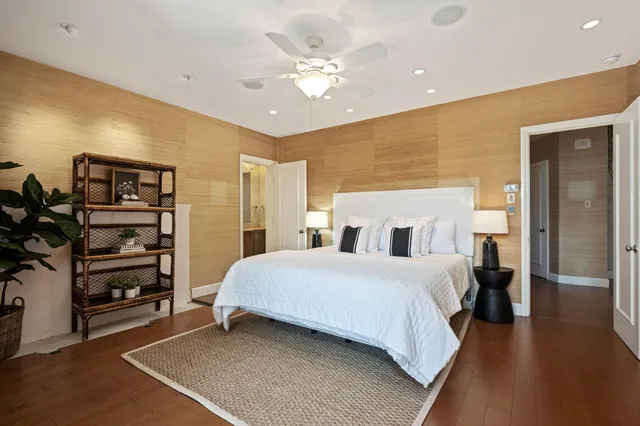 a bedroom with a bed and a ceiling fan