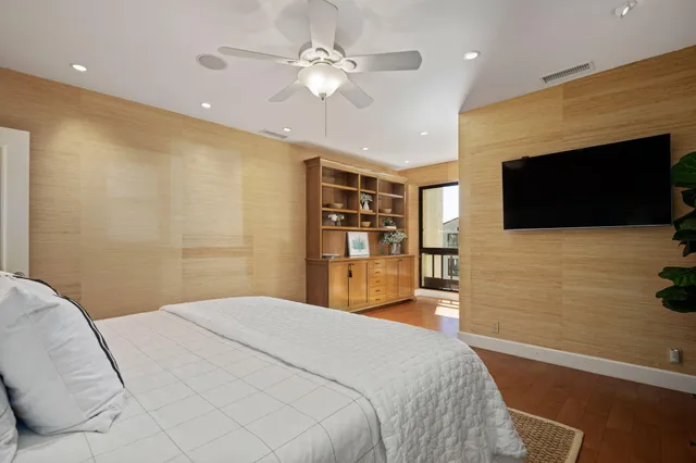 a bedroom with a bed and a flat screen tv