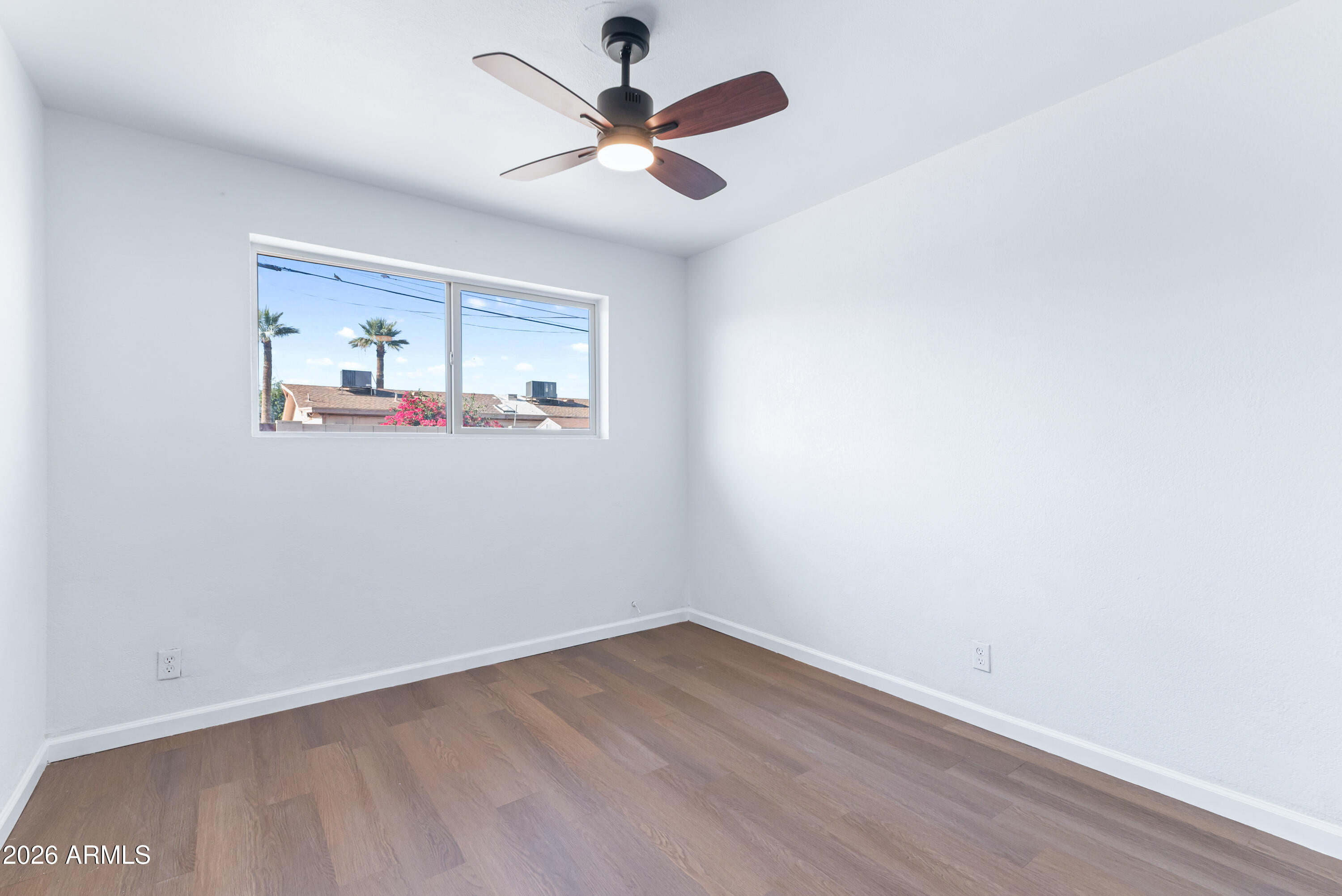 860 West McLellan Road Mesa, AZ 85201 - Photo 18 of 26 an empty room with a window and a ceiling fan