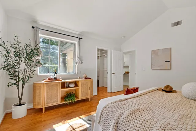 a bedroom with a bed and wooden cabinets