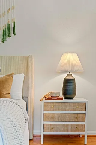 a bedroom with a bed and a lamp