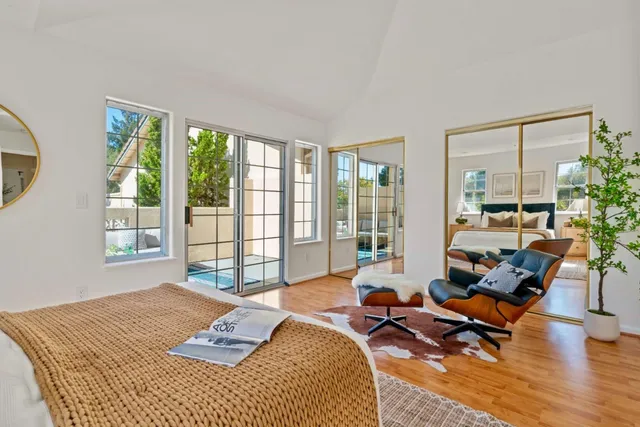 a bedroom with furniture and a large window