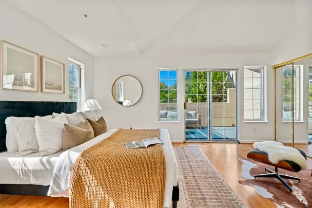 a bed sitting in a bedroom next to a window