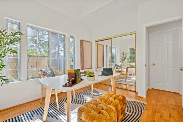 a spacious bathroom with a granite countertop sink mirror and a bathtub