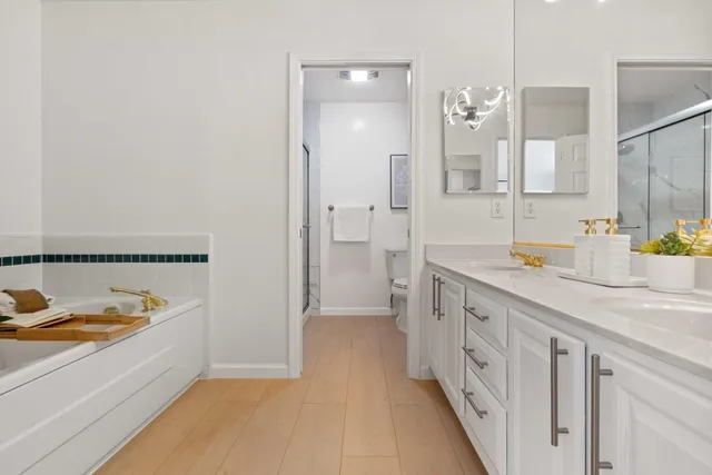 a patio with table and chairs and potted plants