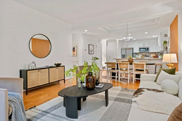 a living room with furniture a rug and a floor to ceiling window