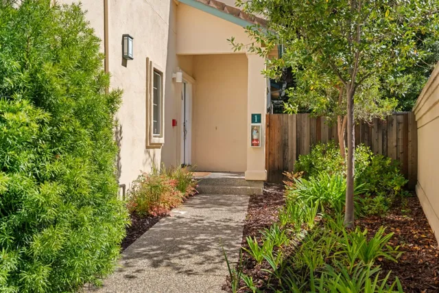 a view of backyard with seating space and trees