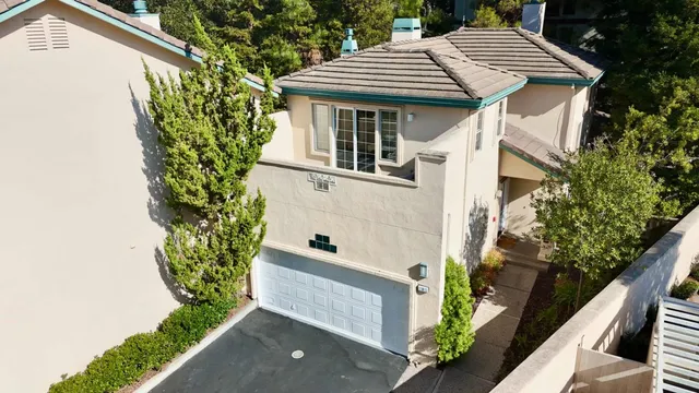 an aerial view of multiple houses with yard