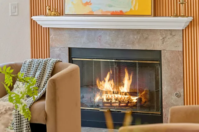 a living room with furniture and a fireplace