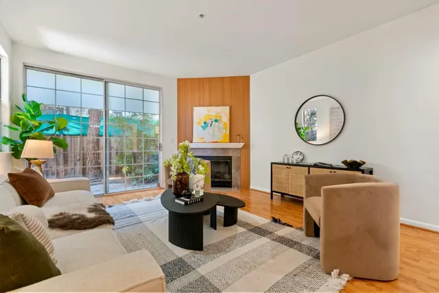 a living room with furniture a window and a potted plant
