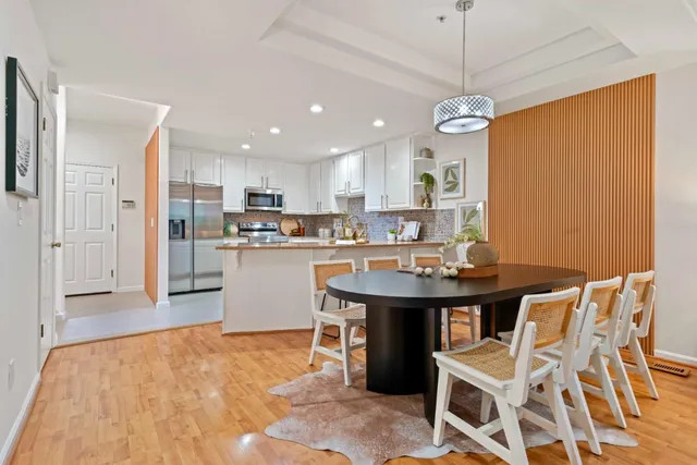 a kitchen with stainless steel appliances granite countertop a sink and a refrigerator