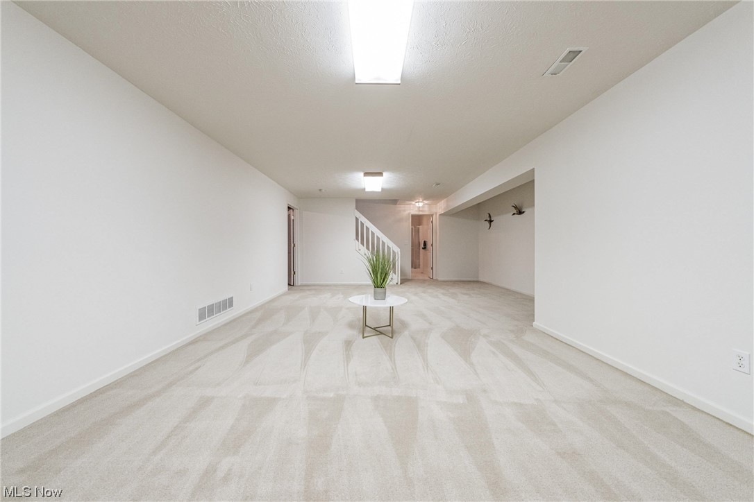 4220 Castle Ridge Akron, OH 44321 - Photo 26 of 35 Spare room with light carpet and a textured ceiling