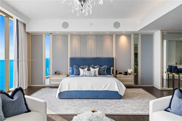 a bedroom with a large bed and a couch