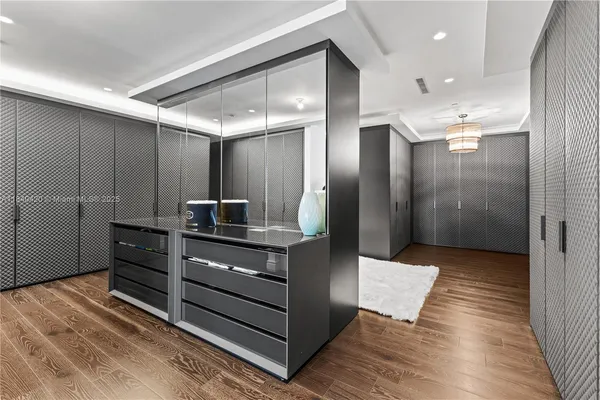 a bedroom with bed and a chandelier