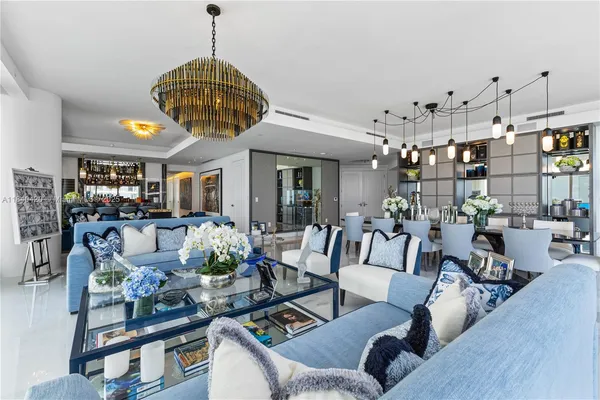 a living room with lots of furniture and a chandelier