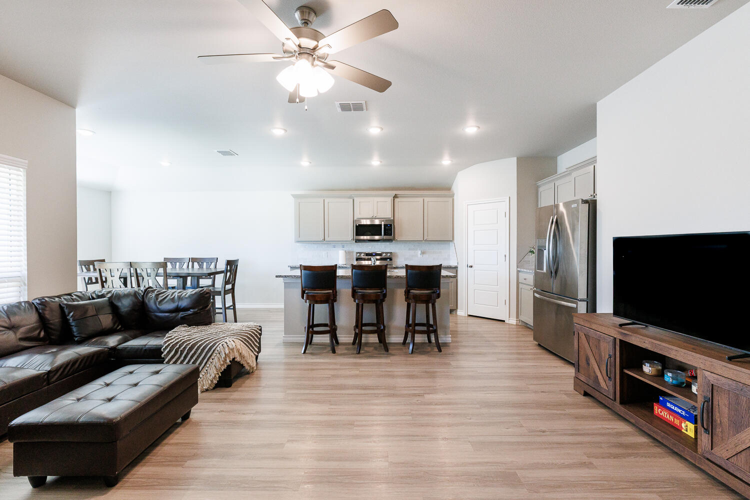 7205 25th Street Lubbock, TX 79407 - Photo 11 of 50 a living room with furniture and a flat screen tv