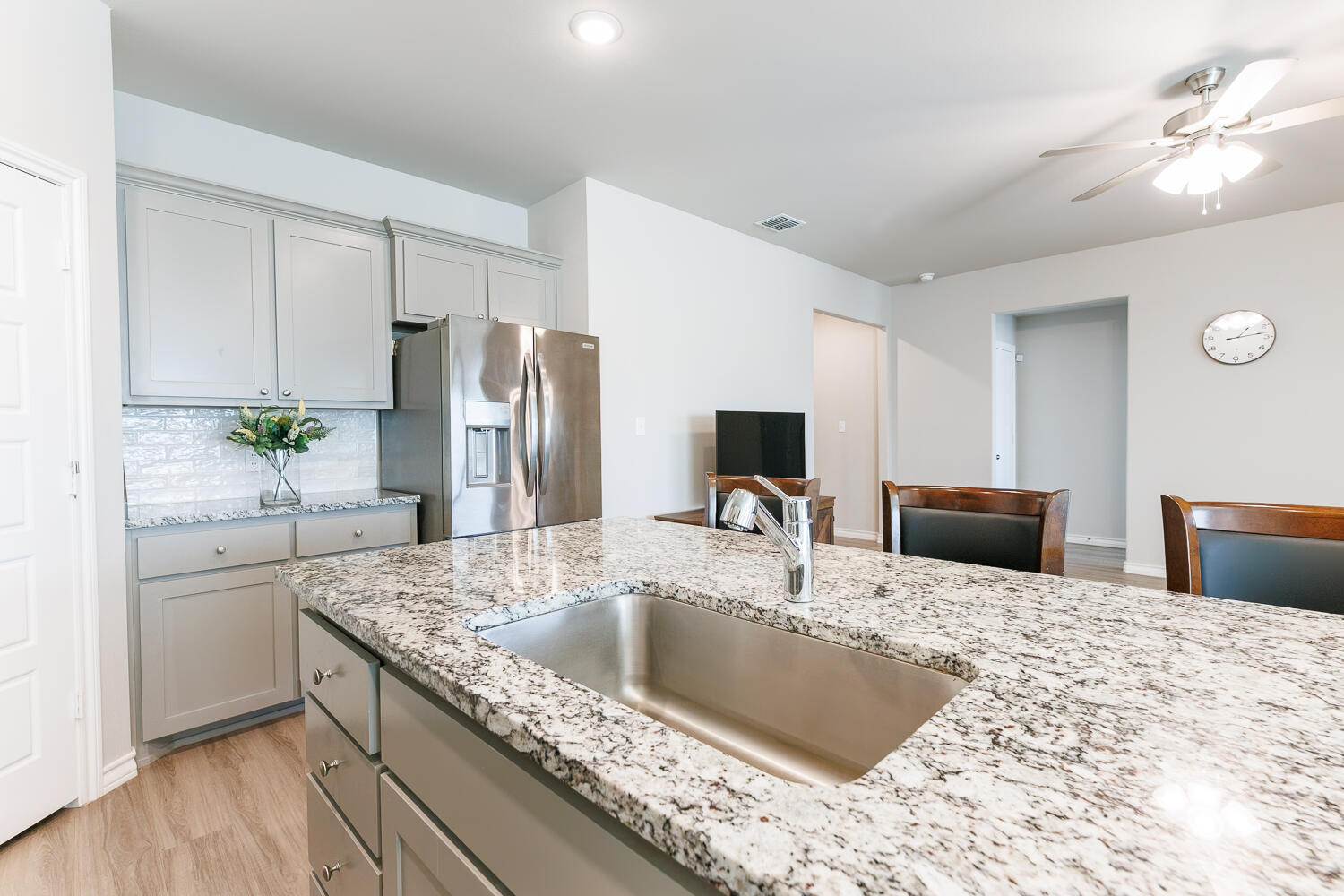 7205 25th Street Lubbock, TX 79407 - Photo 12 of 50 a kitchen with stainless steel appliances granite countertop a sink a stove and a refrigerator