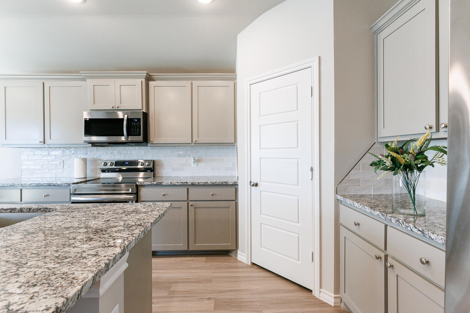 7205 25th Street Lubbock, TX 79407 - Photo 13 of 50 a kitchen with stainless steel appliances granite countertop a stove a sink and a microwave