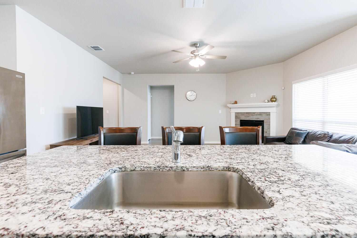 7205 25th Street Lubbock, TX 79407 - Photo 16 of 50 a kitchen with kitchen island granite countertop a sink a counter top space and appliances