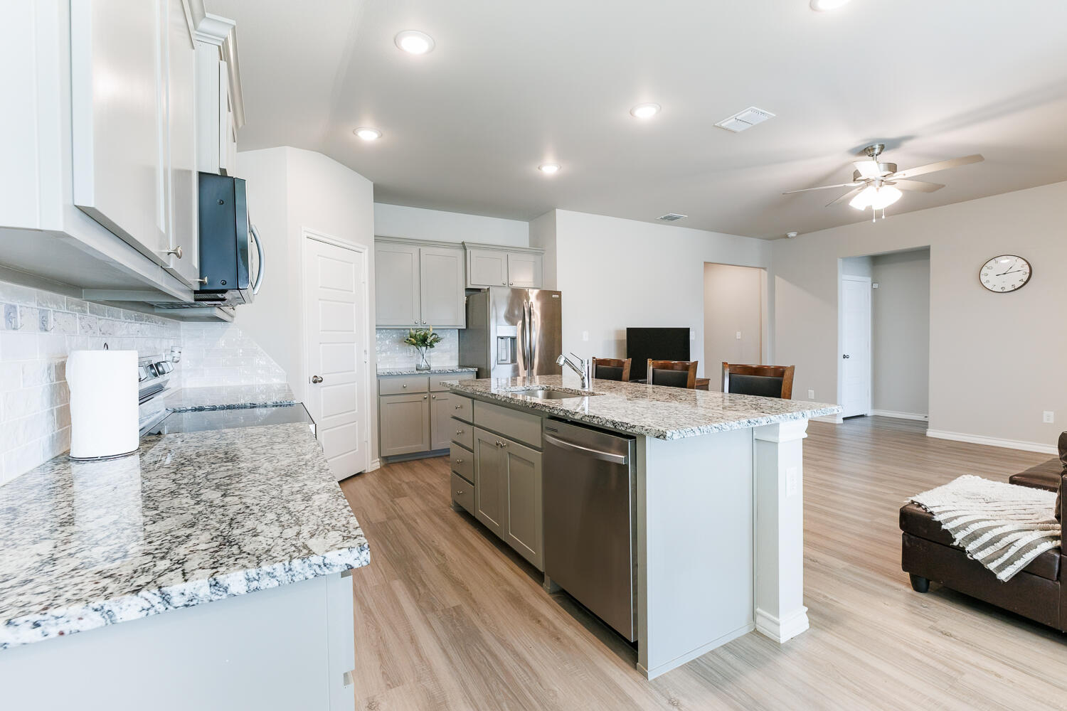 7205 25th Street Lubbock, TX 79407 - Photo 18 of 50 a kitchen with stainless steel appliances granite countertop a sink stove and refrigerator