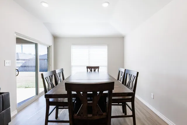 a view of a dining room with furniture and wooden floor