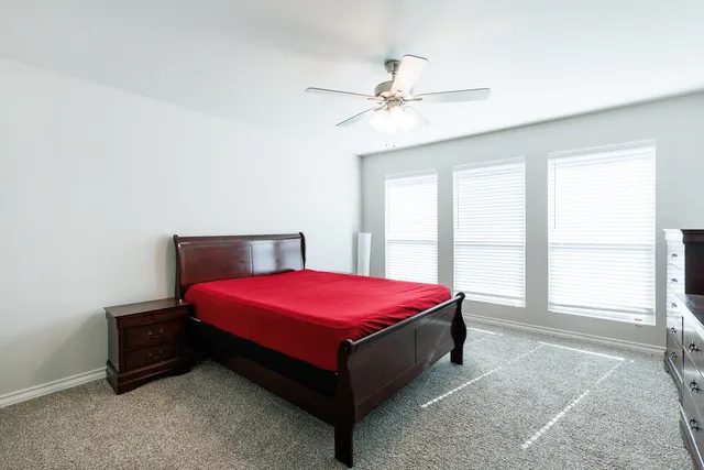 a bedroom with a bed and window