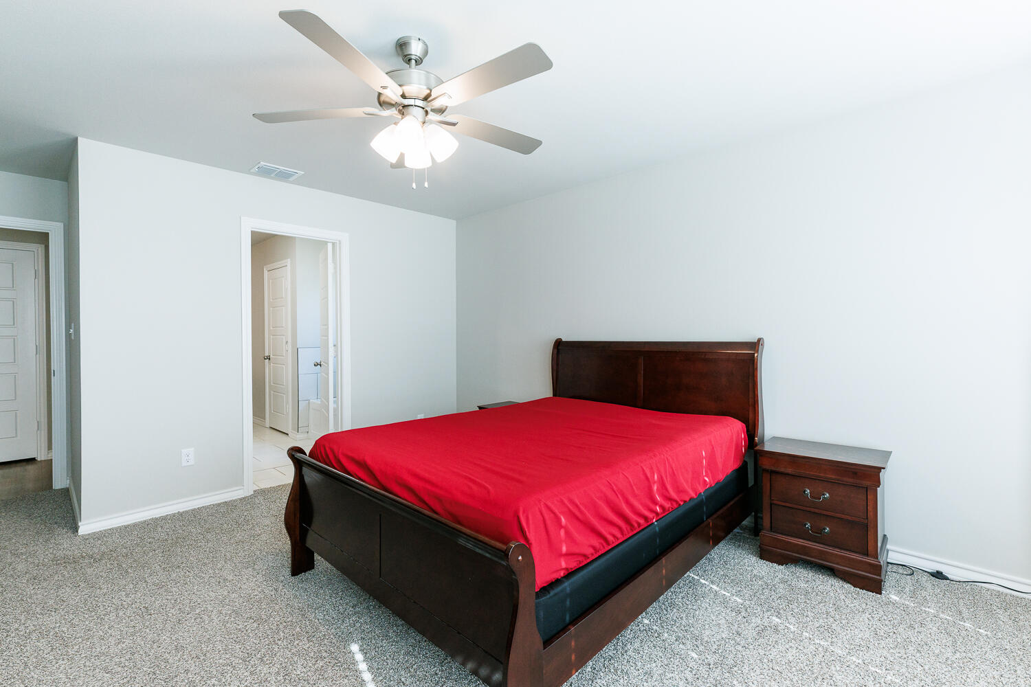 7205 25th Street Lubbock, TX 79407 - Photo 25 of 50 a bedroom with a bed and a chandelier