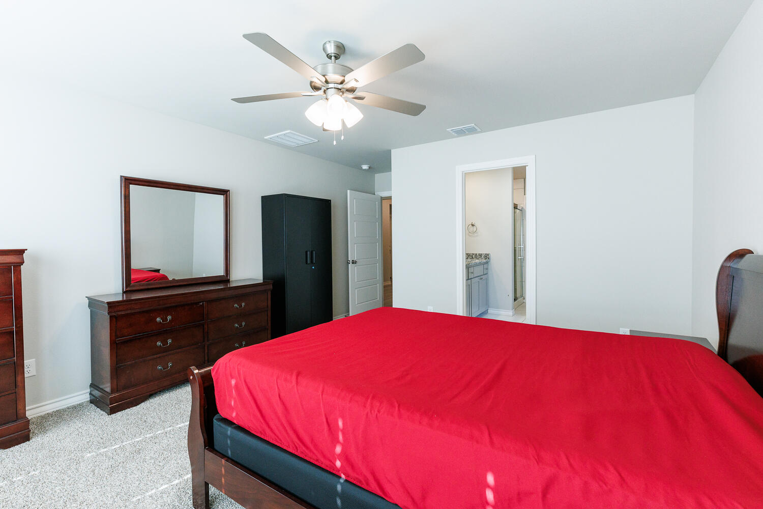 7205 25th Street Lubbock, TX 79407 - Photo 26 of 50 a bedroom with a bed and a dresser