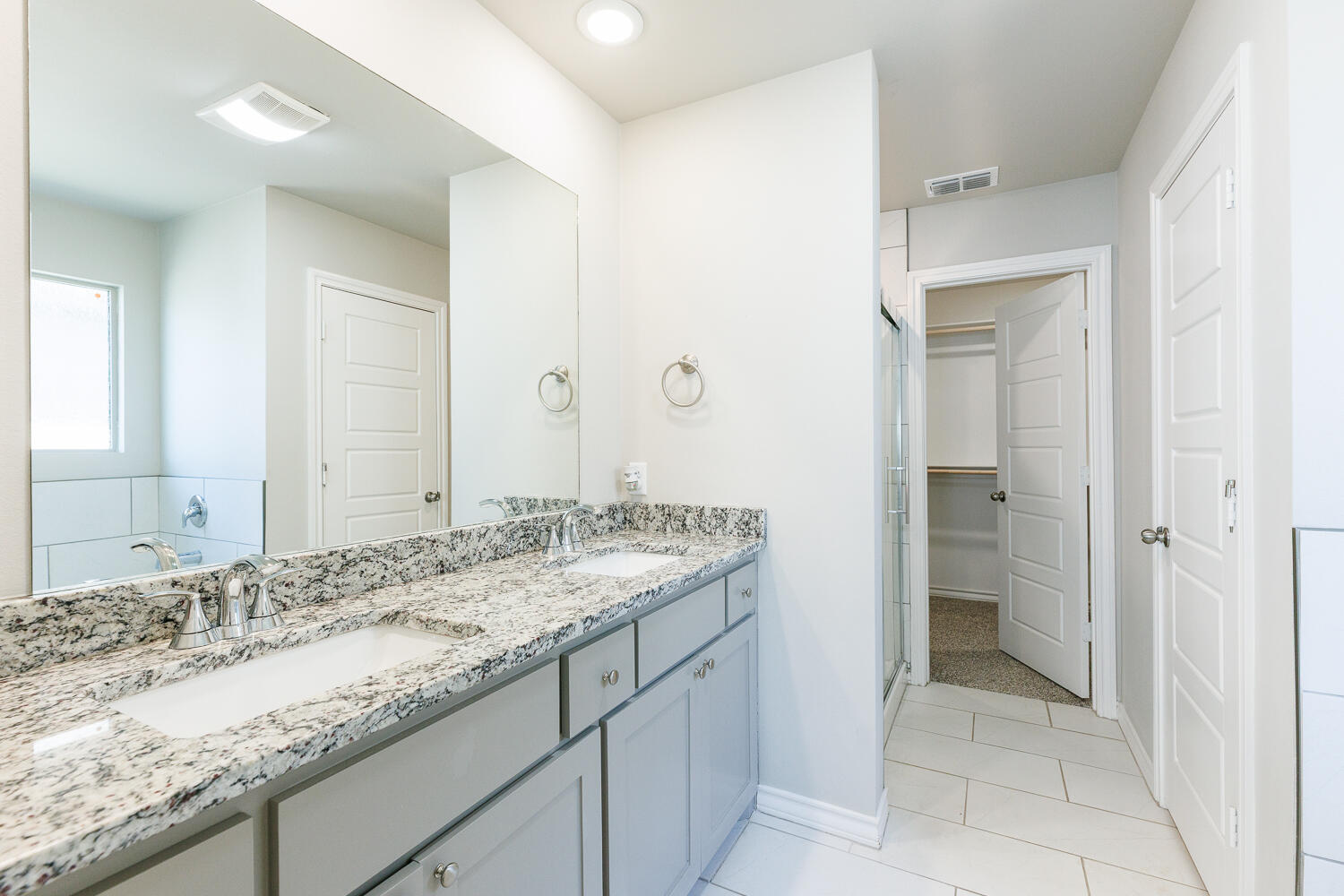 7205 25th Street Lubbock, TX 79407 - Photo 28 of 50 a bathroom with a granite countertop sink and a mirror