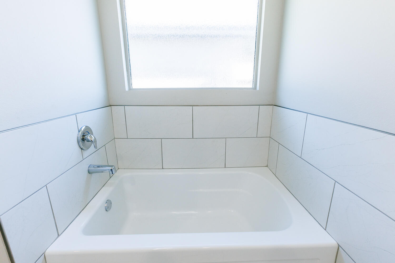 7205 25th Street Lubbock, TX 79407 - Photo 31 of 50 a white bath tub sitting next to a window
