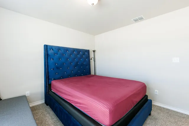 a bed room with a bed and a dresser