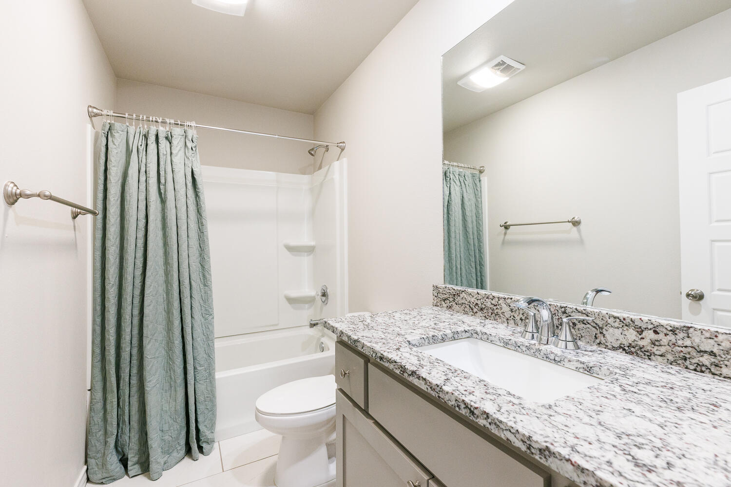 7205 25th Street Lubbock, TX 79407 - Photo 37 of 50 a bathroom with a granite countertop sink toilet and shower