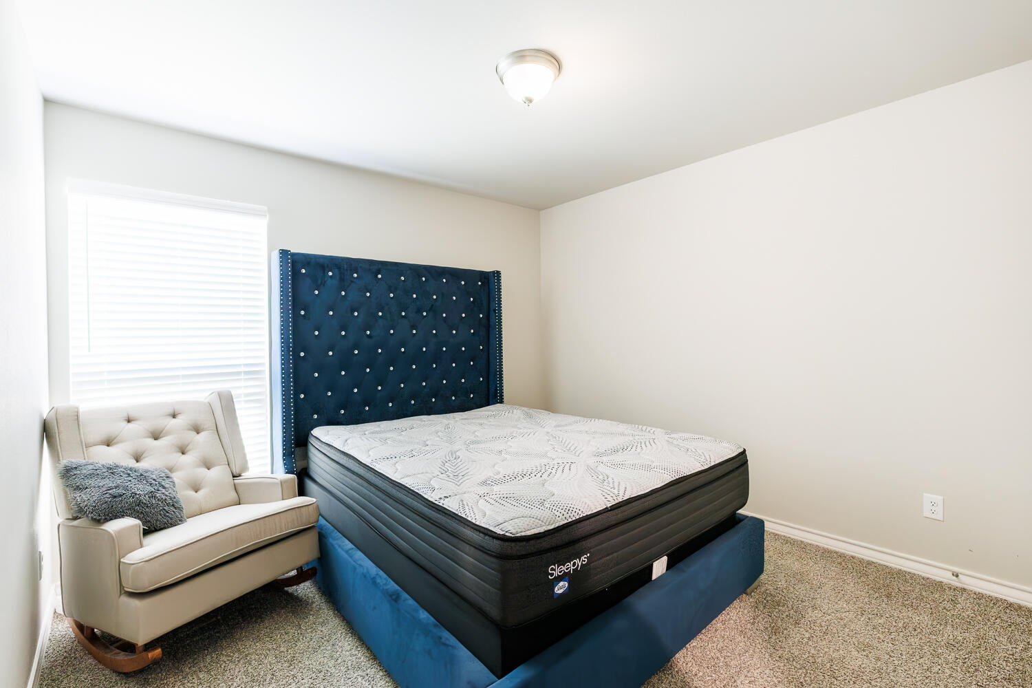 7205 25th Street Lubbock, TX 79407 - Photo 40 of 50 a bed sitting in a bedroom next to a window with cabinet